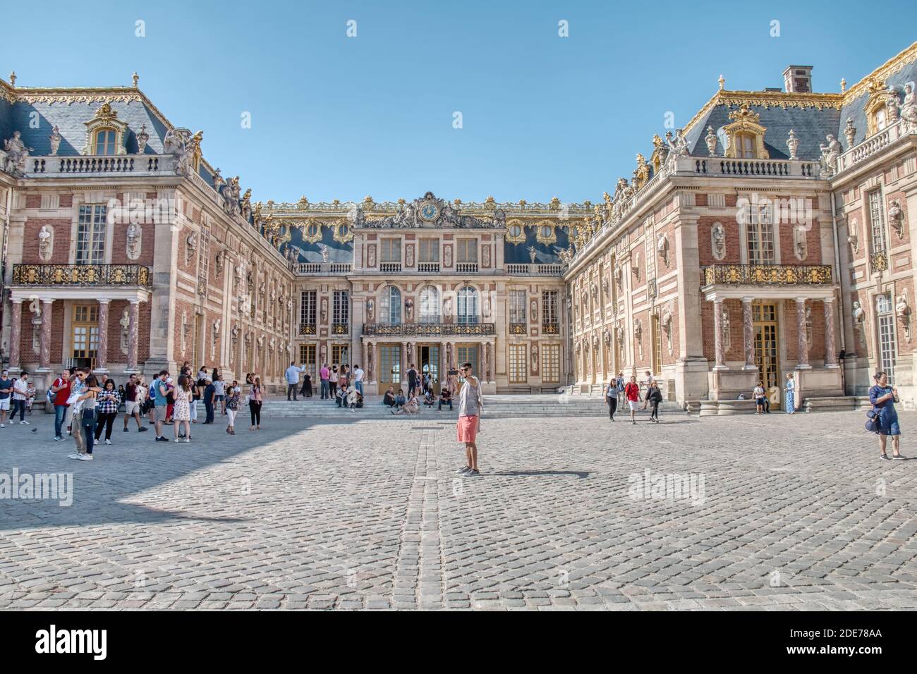 Versailles, France - September 15, 2019: A tourist taking a selfie in front of the Palace of Versailles Stock Photo