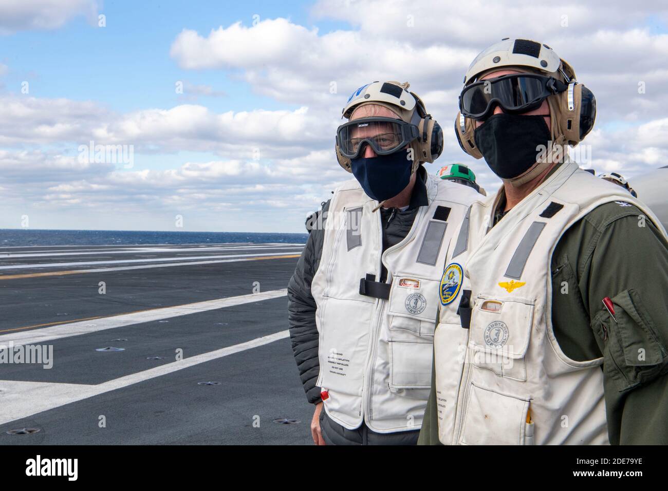U.S. Acting Secretary of Defense Christopher Miller, left, stands on the flight deck of the Ford class nuclear aircraft carrier USS Gerald R. Ford during a visit to the ship November 18, 2020 in the Atlantic Ocean. Stock Photo