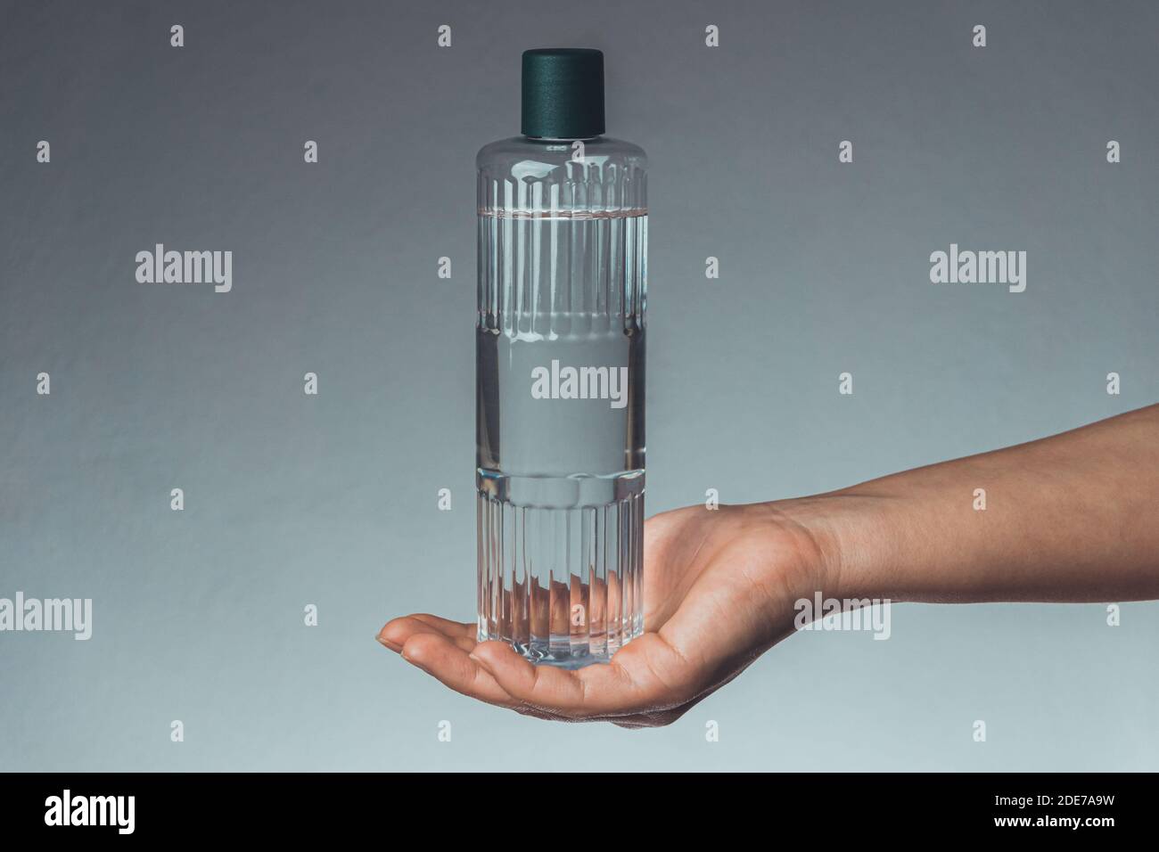 Woman holding Turkish cologne (or eau de cologne and Turkish disinfectant) on her hand. Coronavirus transmission with hands. Covid-19 concept Stock Photo
