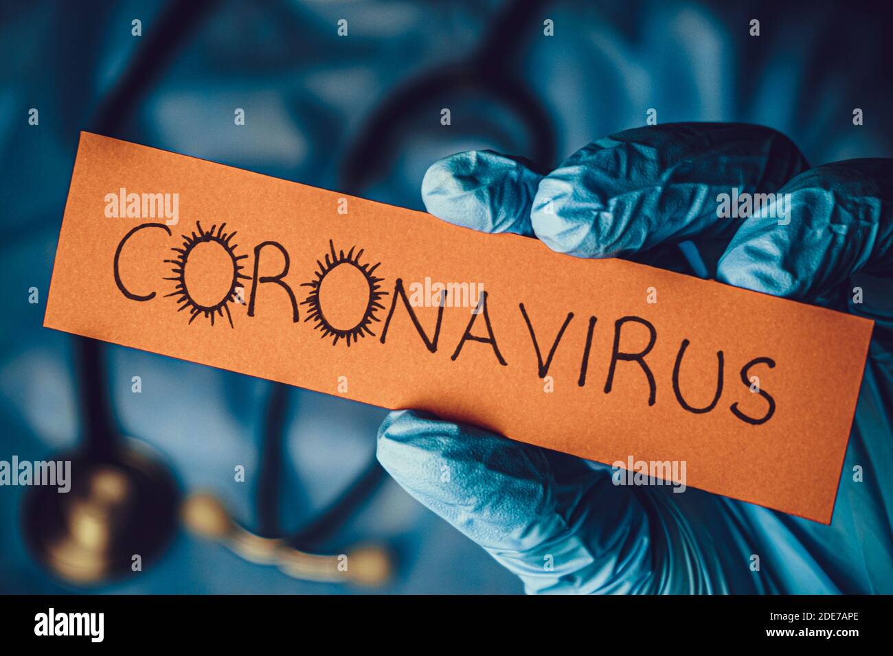 Concept of Covid-19 pandemic.Doctor holding a paper that written coronavirus. Stock Photo
