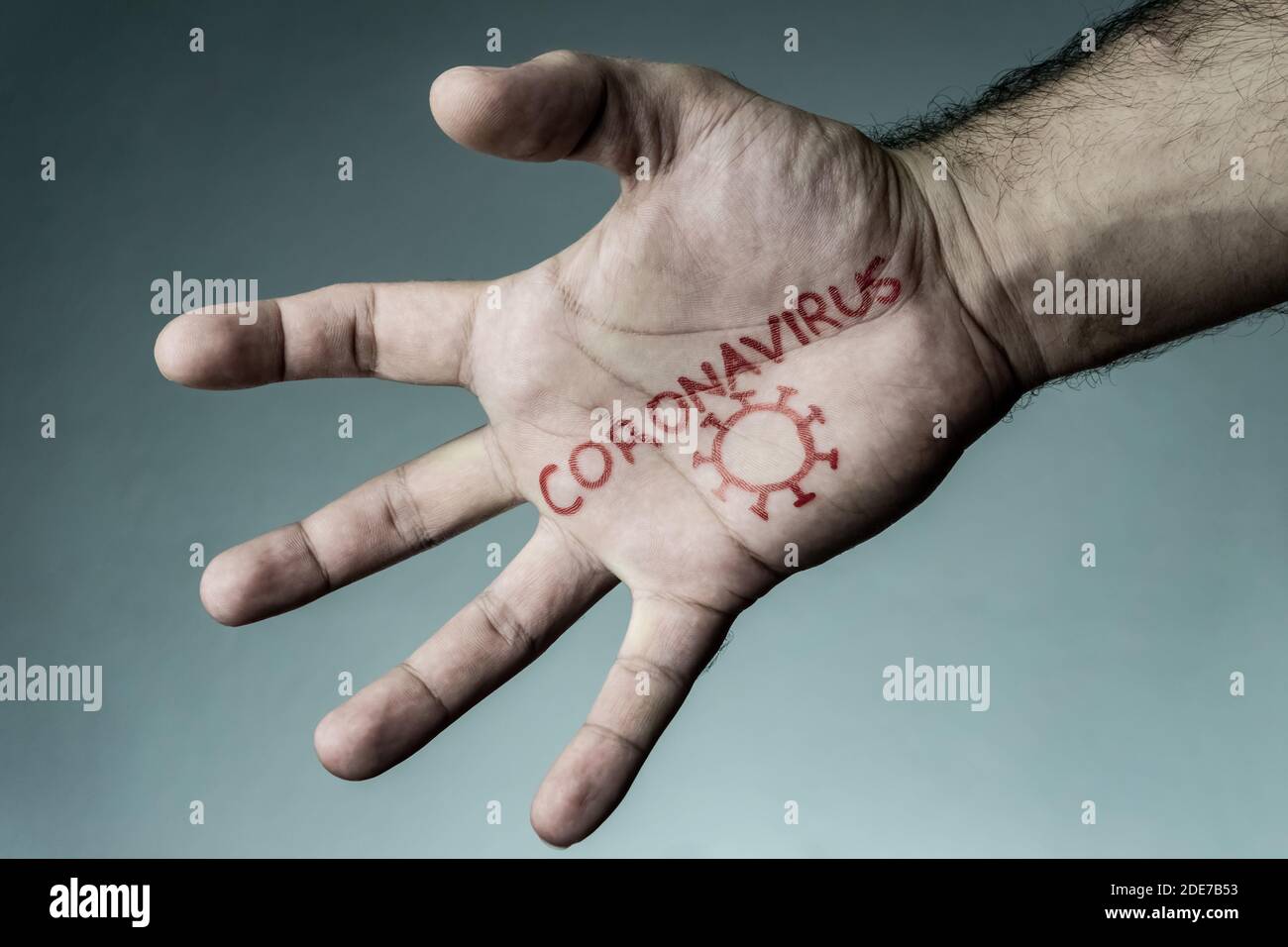 Coronavirus text written on hand of man. Covid-19, Coronavirus, SARS-CoV-2 outbreak. Coronavirus concept and background. Stock Photo