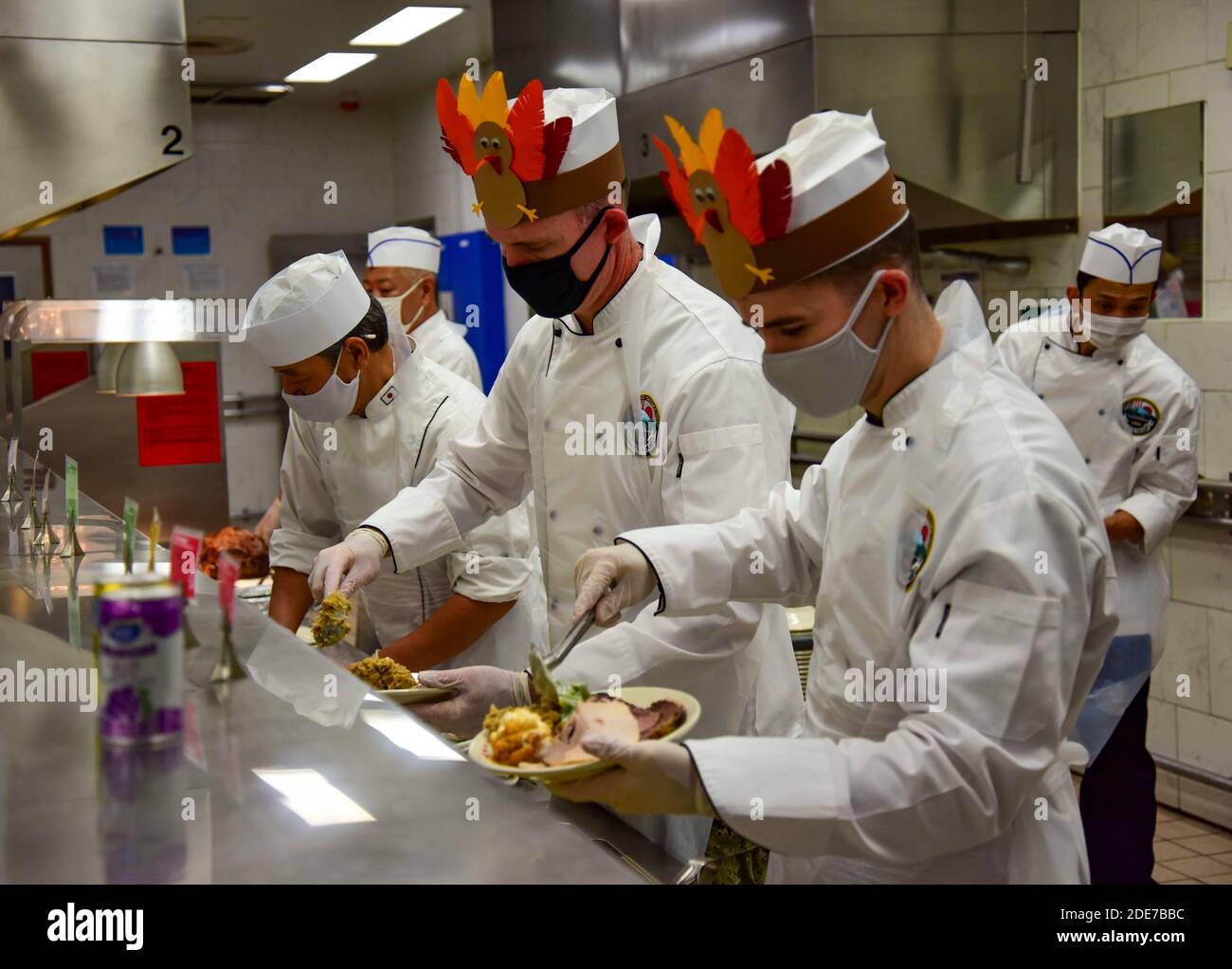 U.S. Navy Capt. Rich Jarrett, Commander, Fleet Activities Yokosuka assists in serving traditional Thanksgiving dinner to service members at Yokosuka Naval Base November 26, 2020 in Yokosuka, Japan. Stock Photo