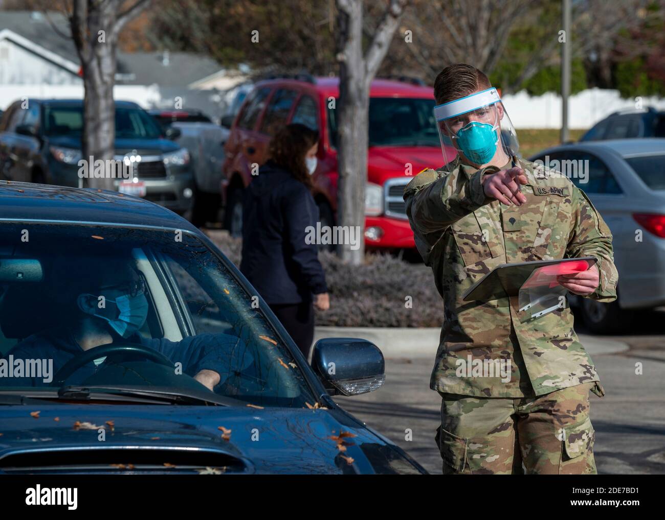 An Idaho Army National Guardsman directs a driver during a COVID19