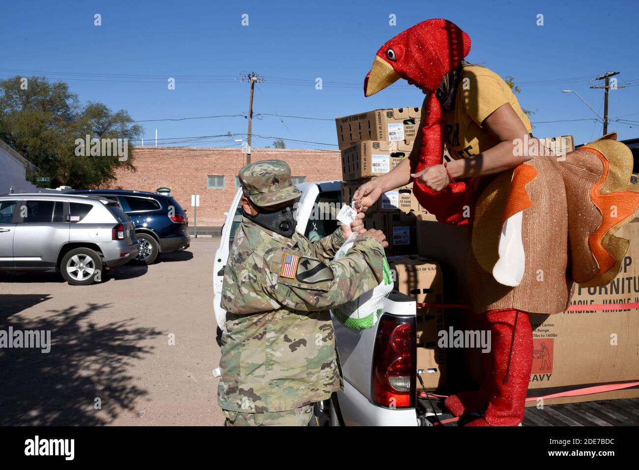 Arizona National Guard service members deliver food supplies to Native American residents at a food bank November 24, 2020 in Casa Grande, Arizona. The pandemic has caused an increase in food insecurity with long lines at food banks across the country. Stock Photo