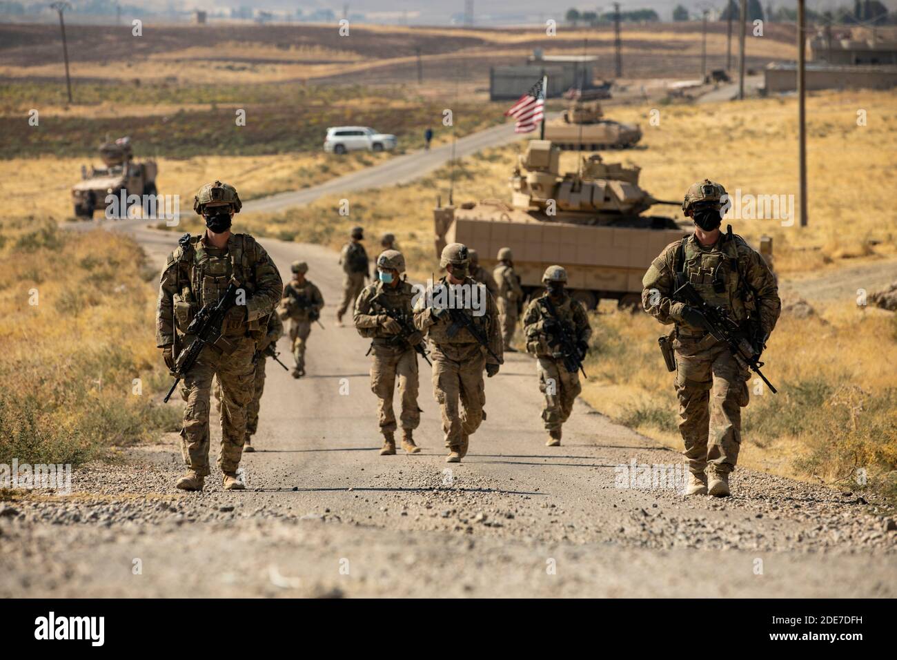 U.S. Army soldiers patrol a road in Northern Syria October 26, 2020 near Qamishli, Syria. The soldiers are in Syria to support Combined Joint Task Force Operation Inherent Resolve against the Islamic State fighters. Stock Photo