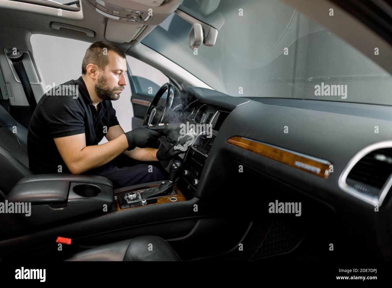 Disinfecting the car interior, steam heat disinfection of vehicles. Young  bearded man worker, cleaning car air conditioner and control panel with  high Stock Photo - Alamy