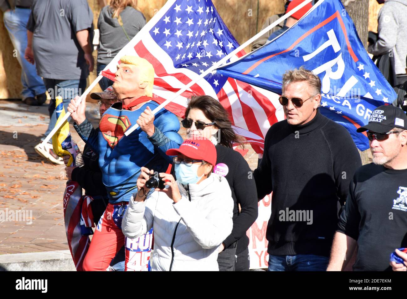 Washington DC. Nov 14, 2020. Million Maga March. A man wearing Trump superman outfit walking with American flag and Trump flag at Freedom Plaza. Stock Photo