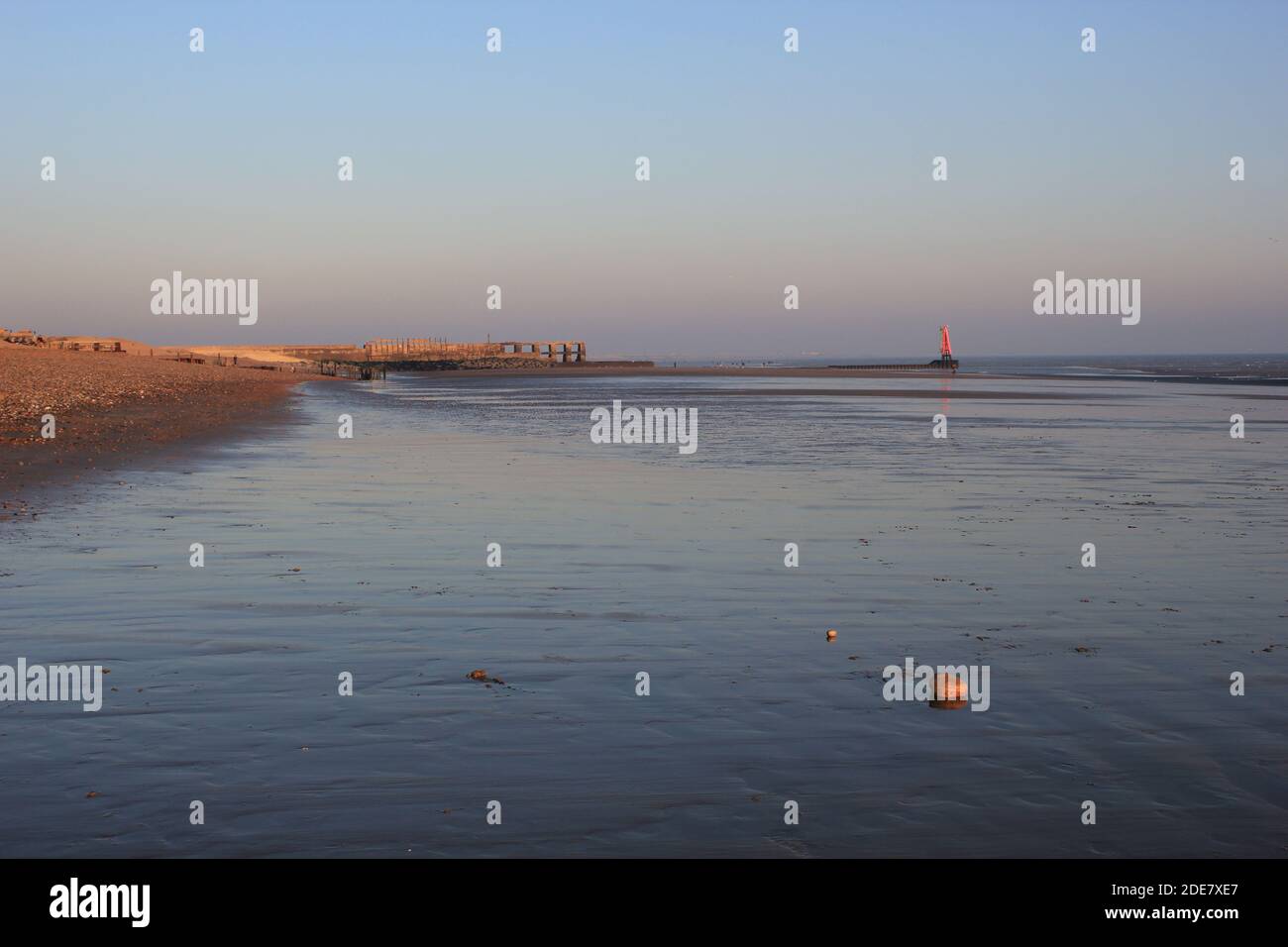 Winchelsea beach landscape view low tide exposing flat sand with wooden