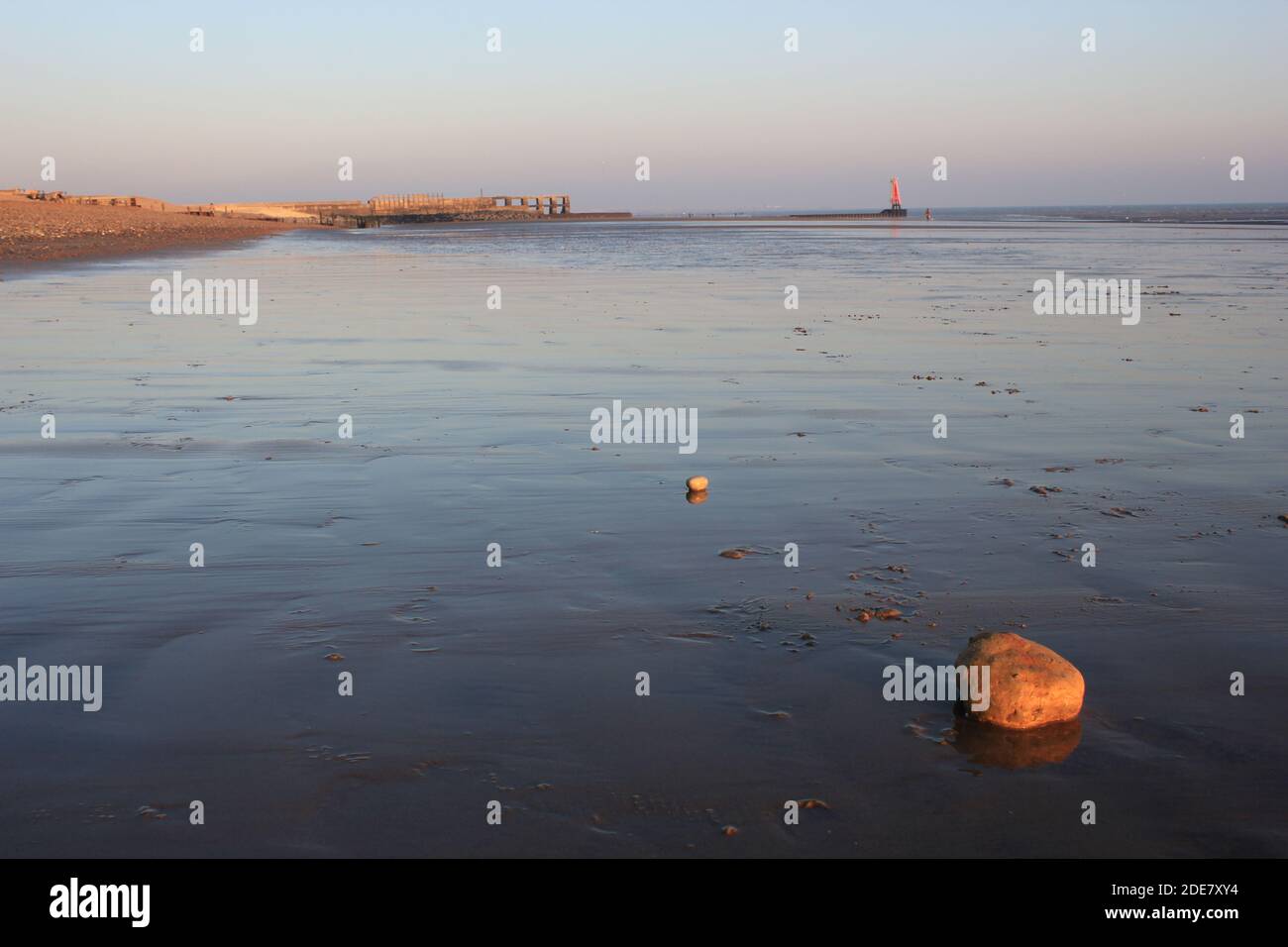 Winchelsea beach landscape view low tide exposing flat sand with wooden