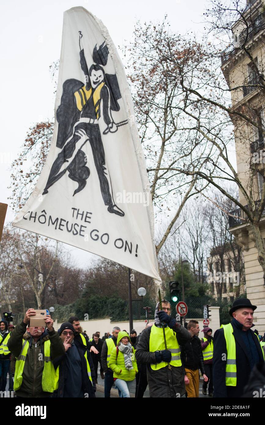 A man carries a sign with a play on words with the hit 'Show must go on' of Queen during the 10th act of the yellow vests demonstration in Paris on January 19, 2019. Photo by Julie Sebadelha/ABACAPRESS.COM Stock Photo