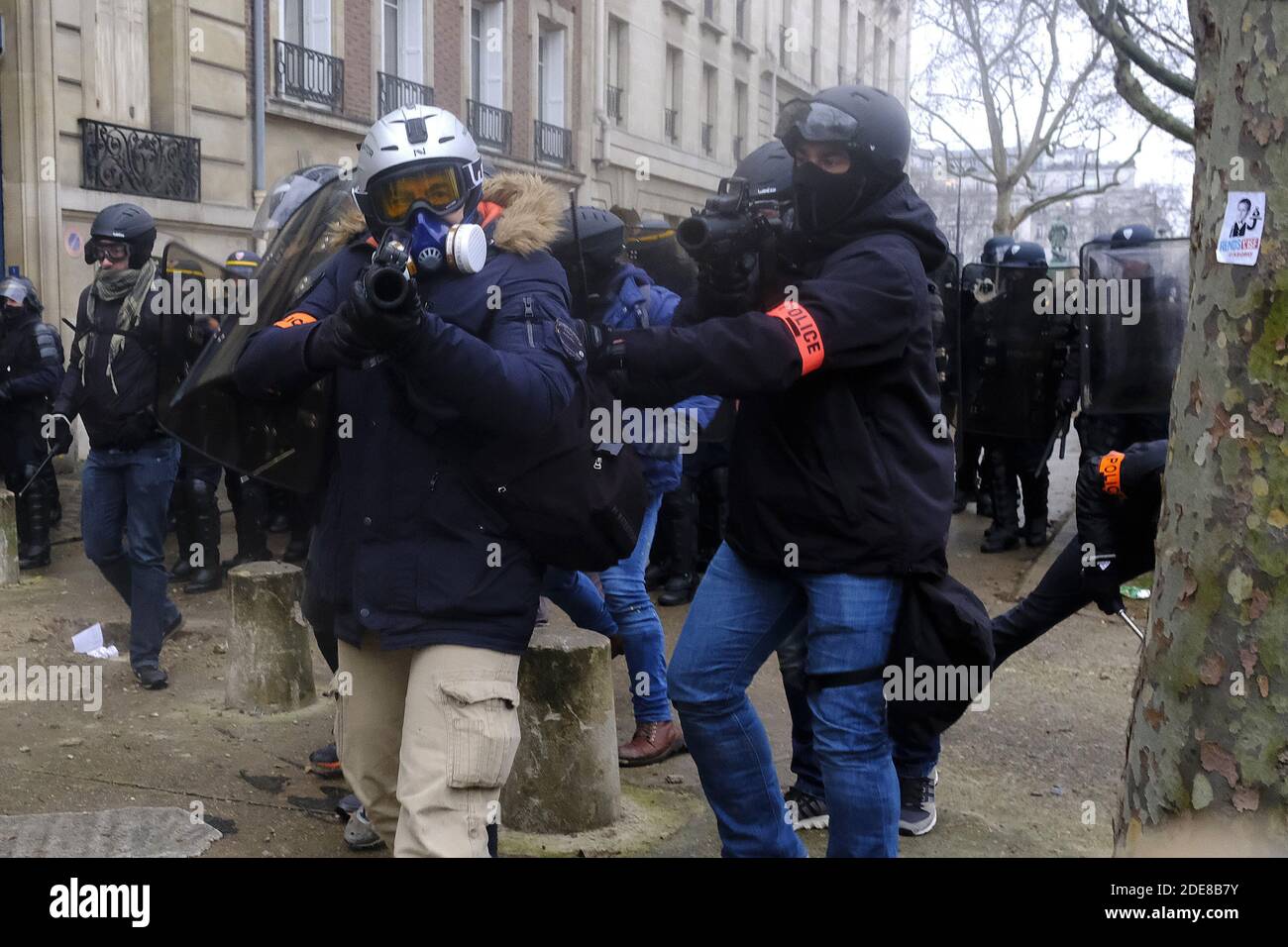 French Plainclothes police officers armed with LBD 40, Flash-Ball targeting  demonstrators.during clash with French riot police (CRS), for the 10th  consecutive near the Hotel des Invalides in Paris. its beginning on November