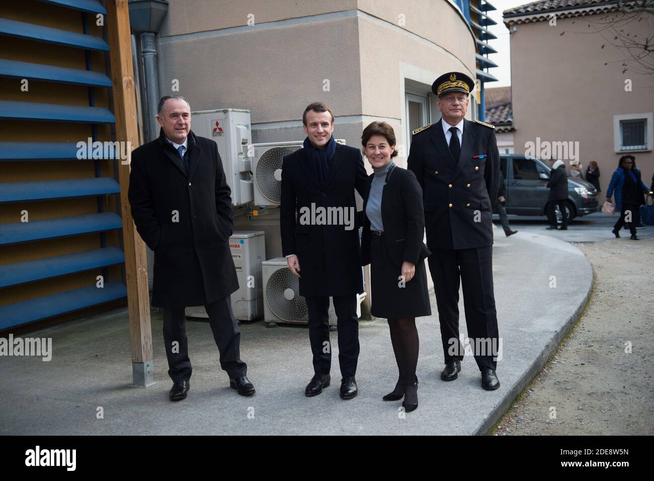 French President Emmanuel Macron stands with Didier Guillaume (L), French  Agriculture Minister, Nathalie Nieson (M), Bourg-de-Peage mayor's and Eric  Spitz (R) , Drome's prefect as they are to visit an elderly house (