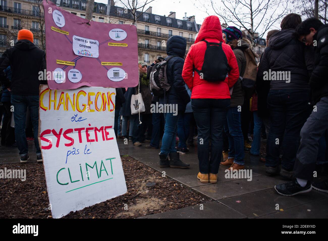 A sign 'Change the system, not the climate'' is hanging on a tree during a gathering for climate in Paris, France, on January 27, 2019. Photo by Julie Sebadelha/ABACAPRESS.COM Stock Photo
