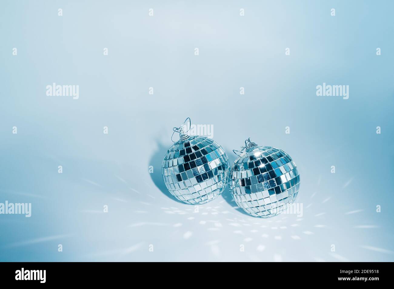 Two disco balls on blue background with reflections, copyspace Stock Photo