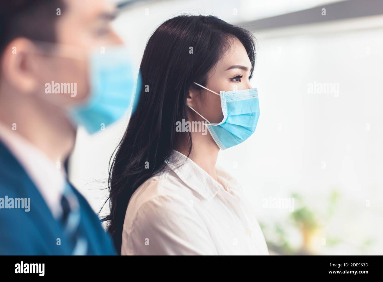 Business people wearing medical face mask while working in office Stock Photo