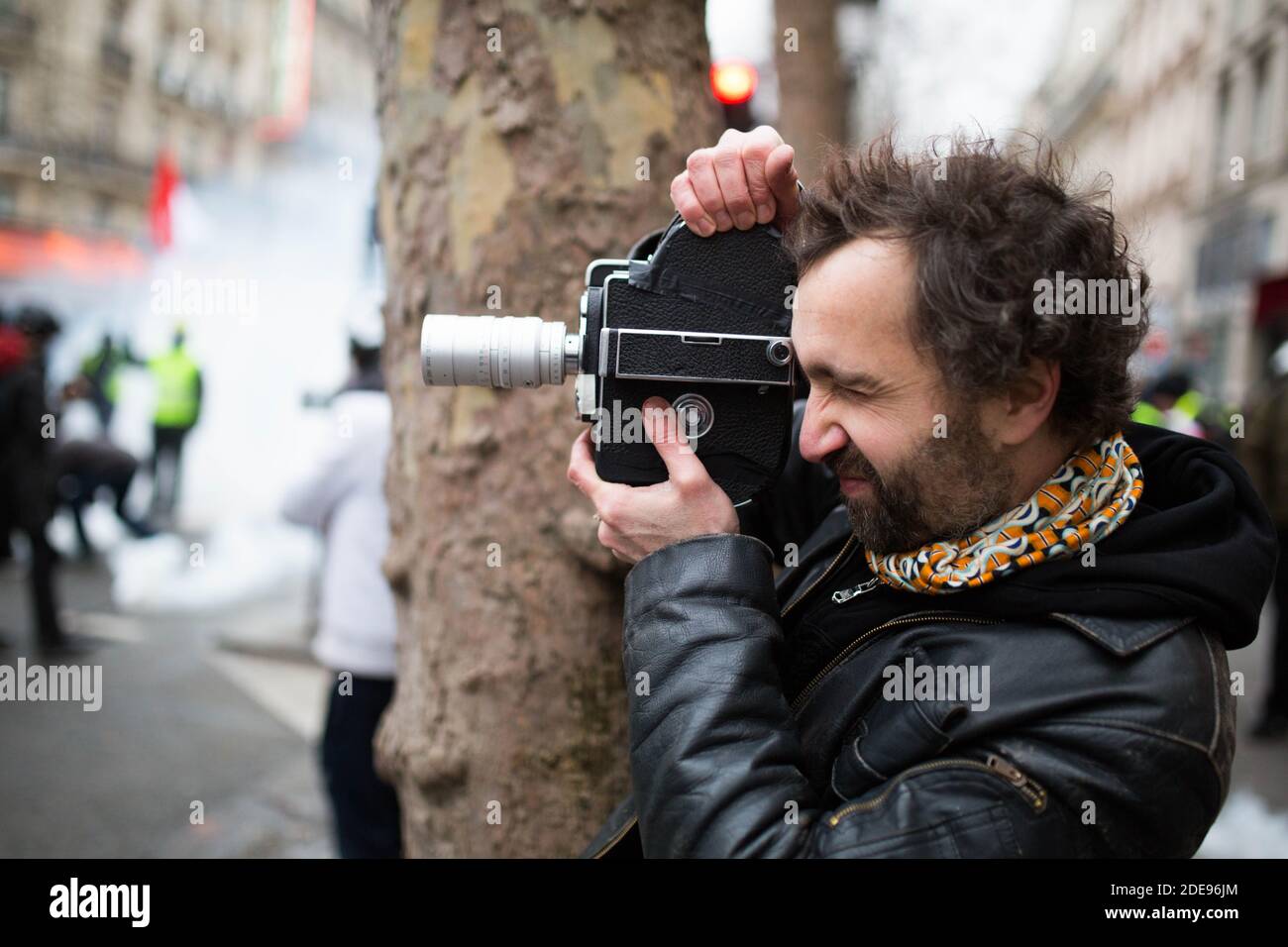 Journalist with a vintage camera (16MM) during Yellow vest protest (Gilets  Jaunes) in place de la Republique Paris on February 2, 2019 on the  sidelines of a march called to pacifically protest