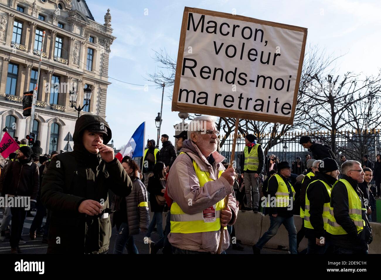 A retired demonstrator holds a sign that reads 'Macron thief, give me back my pension'. Several thousand demonstrators from CGT unions, Gilets Jaunes (Yellow Jackets), and students marched between Place de l'Hotel de Ville and Place de la Concorde as part of the national strike day to demand increased purchasing power and tax justice. Paris, France, February 5, 2019. Photo by Samuel Boivin / ABACAPRESS.COM Stock Photo