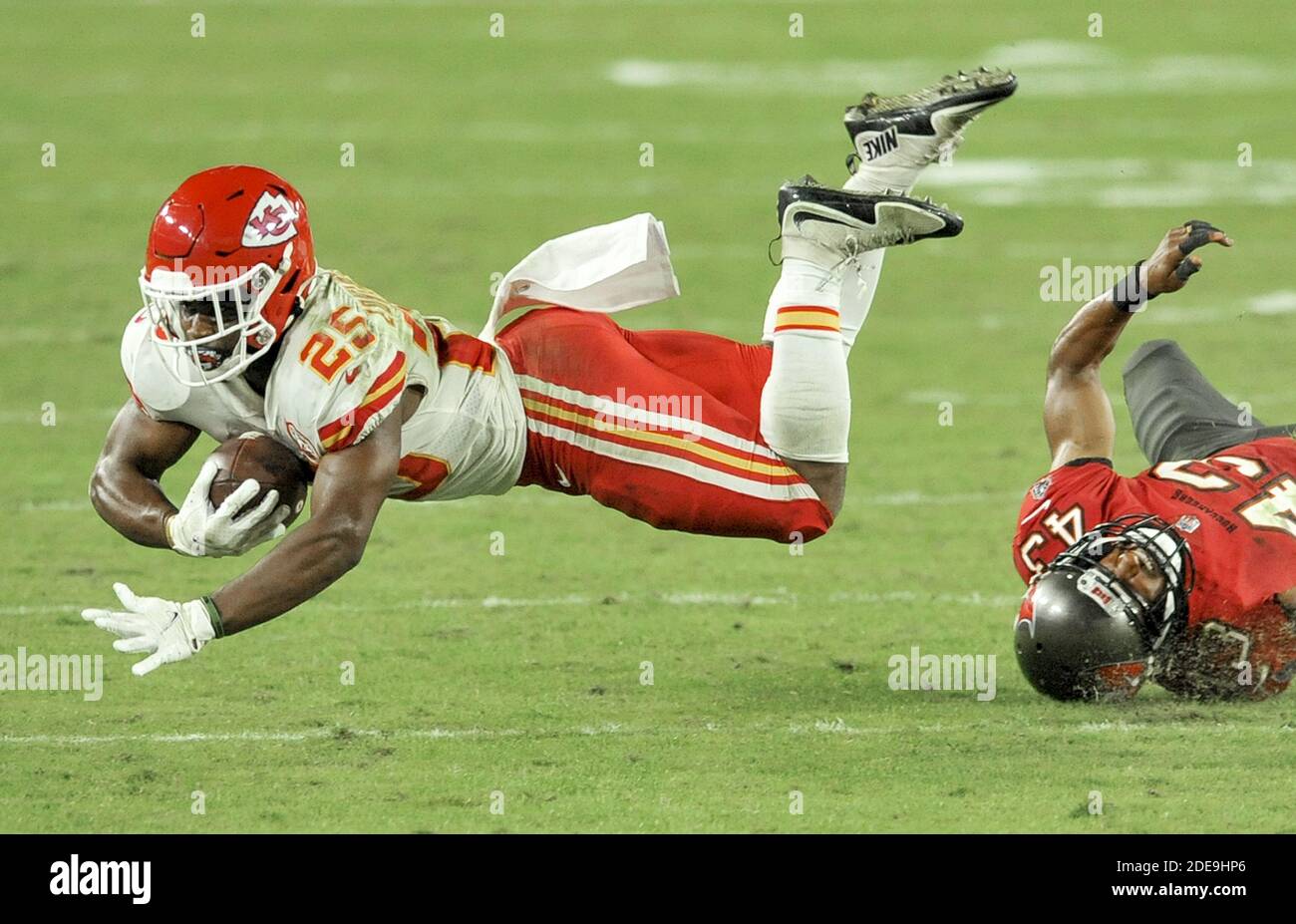 Tampa, United States. 29th Nov, 2020. Kansas City Chiefs running back Clyde  Edwards-Helaire (25) flies over Tampa Bay Buccaneers' Ross Cockrell (43)  during the fourth quarter at Raymond James Stadium in Tampa,