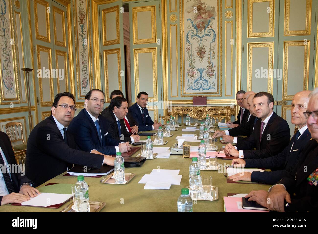 Tunisian prime minister Youssef Chahed (3L) and his delegation meets with French president Emmanuel Macron (3R), Foreign Affairs minister Jean-Yves Le Drian (4R), diplomatic advisor Philippe Etienne (5R), French ambassador in Tunisia Olivier Poivre d'Arvor (2R) and admiral Bernard Rogel (R) in the green meeting room in the Elysee Palace in Paris on February 15, 2019. Photo by Pierre Villard/pool/ABACAPRESS.COM Stock Photo