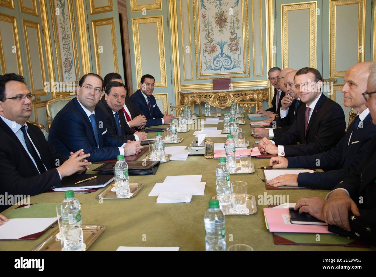 Tunisian prime minister Youssef Chahed (3L) and his delegation meets with French president Emmanuel Macron (3R), Foreign Affairs minister Jean-Yves Le Drian (4R), diplomatic advisor Philippe Etienne (5R), French ambassador in Tunisia Olivier Poivre d'Arvor (2R) and admiral Bernard Rogel (R) in the green meeting room in the Elysee Palace in Paris on February 15, 2019. Photo by Pierre Villard/pool/ABACAPRESS.COM Stock Photo