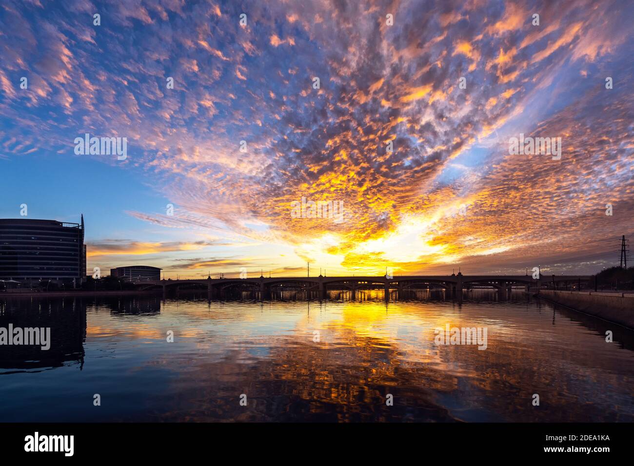 Sunset skies so insane the water below ignites with fire at Tempe Town Lake near Phoenix in Tempe, Arizona Stock Photo