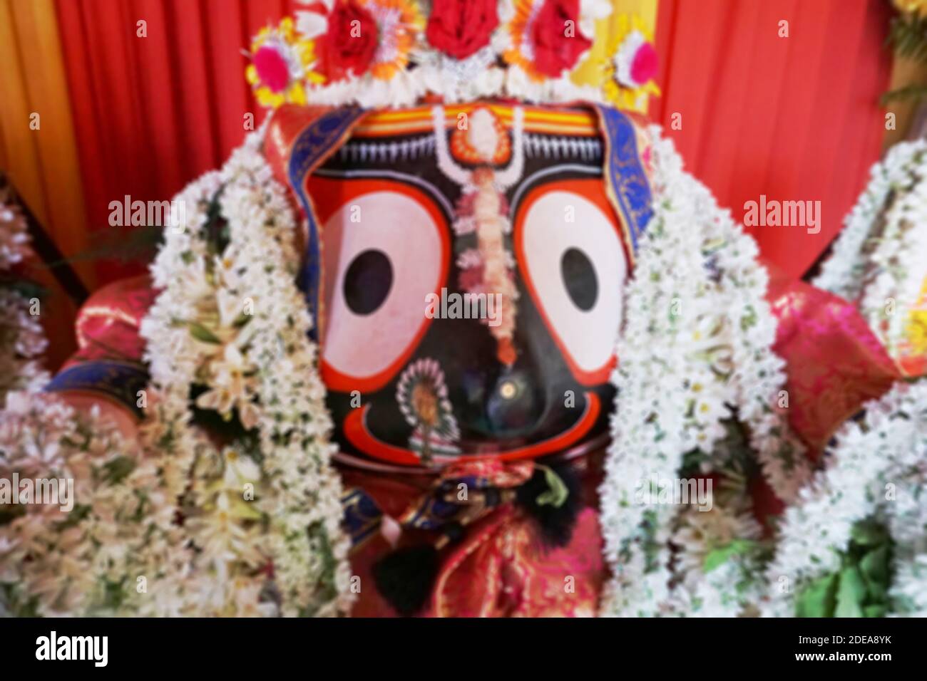 Blurred image of Idol of Hindu God Jagannath. Lord Jagannath is being worshipped with garlands for Rath jatra festival - at Howrah, West Bengal, India Stock Photo