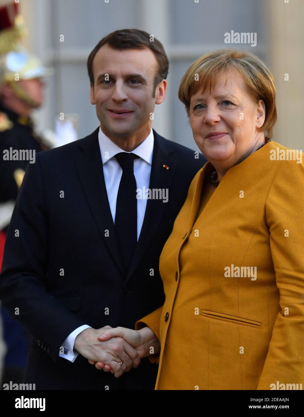 French President Emmanuel Macron greets German Chancellor Angela Merkel