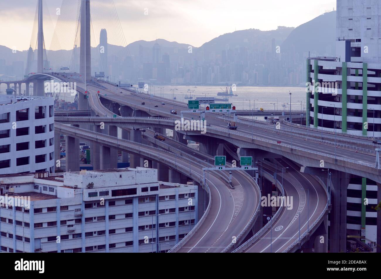 Approach to the Stonecutters Bridge, Hong Kong, next to industrial buildings on Tsing Yi Stock Photo