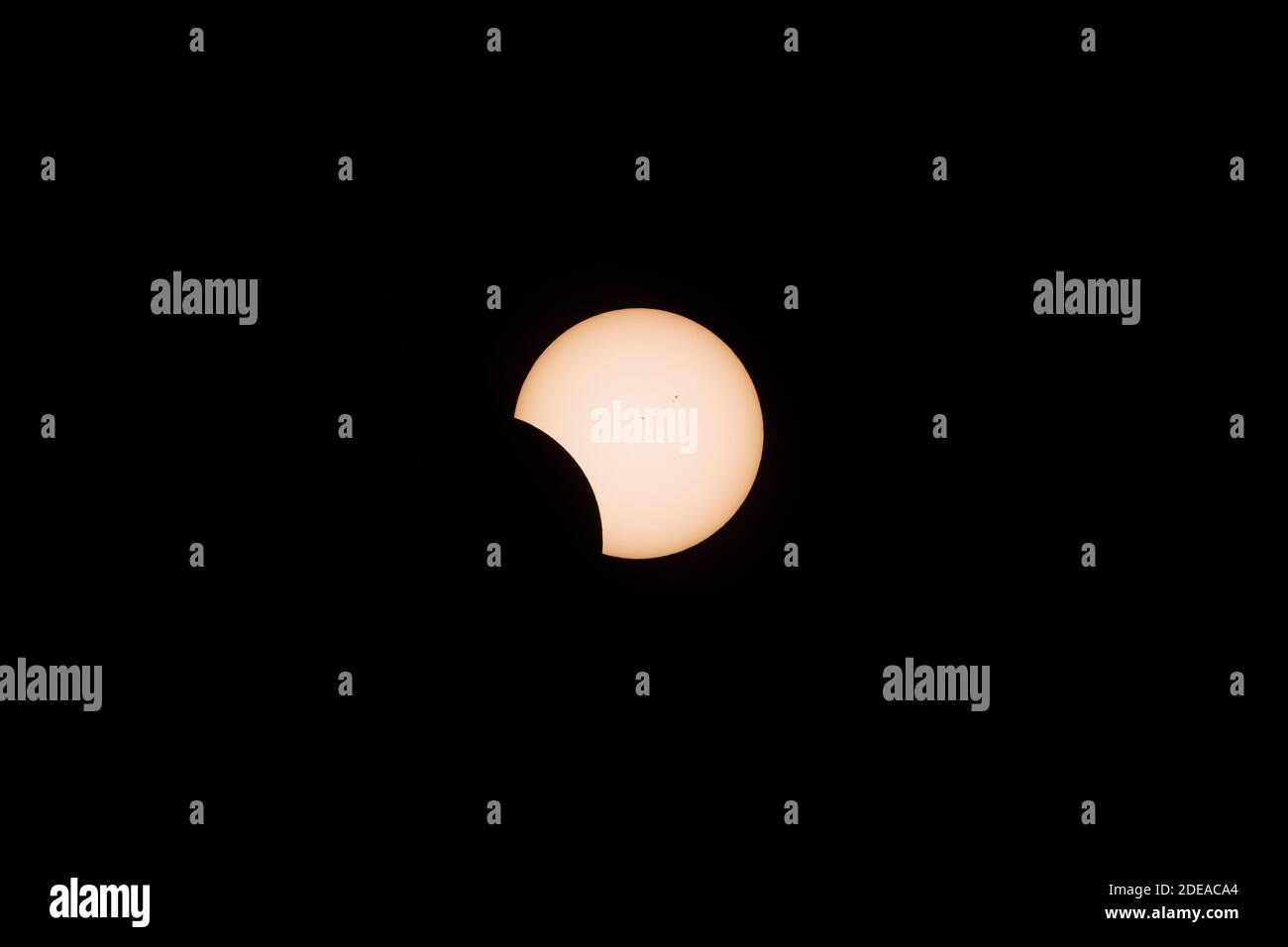 The total solar eclipse on 21 August 2017, as seen from Idaho. About 141 minutes after first contact. Note dark sunspots on the surface.  Yellow filtr Stock Photo