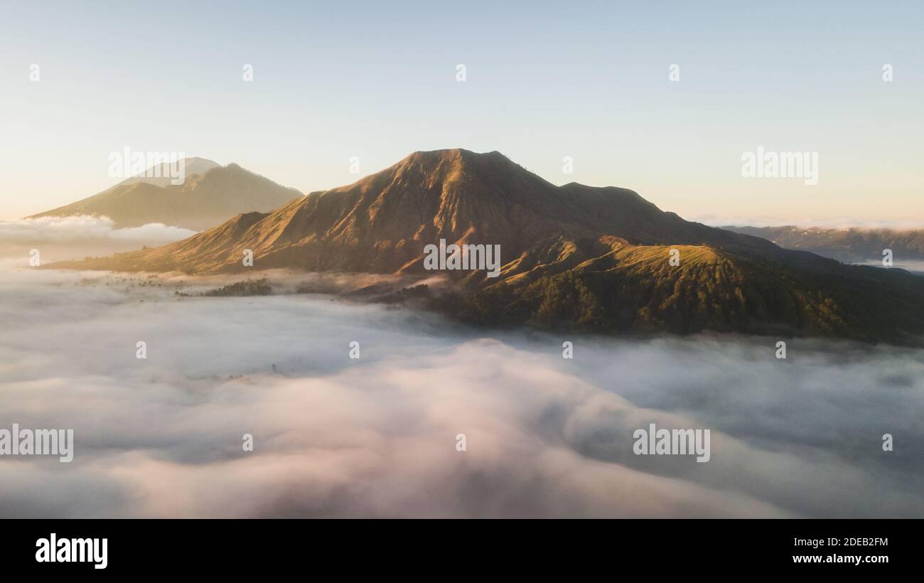 Aerial view of mount Batur volcano in Bali. Beautiful sunrise and low ...