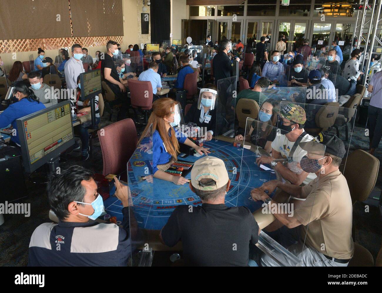 Patrons gather at one of 45 card tables in what used to be the valet area of Gardens Casino in Hawaiian Gardens, California, on Wednesday, October 21, 2020. Partitions and seats are sanitized each time a customer gets up to prevent the spread of the coronavirus. Card clubs in Los Angeles County reopened in early October with health precautions, drawing a stream of gamblers and expressions of relief from city leaders who have struggled without the key source of tax revenue. Photo by Jim Ruymen/UPI Stock Photo