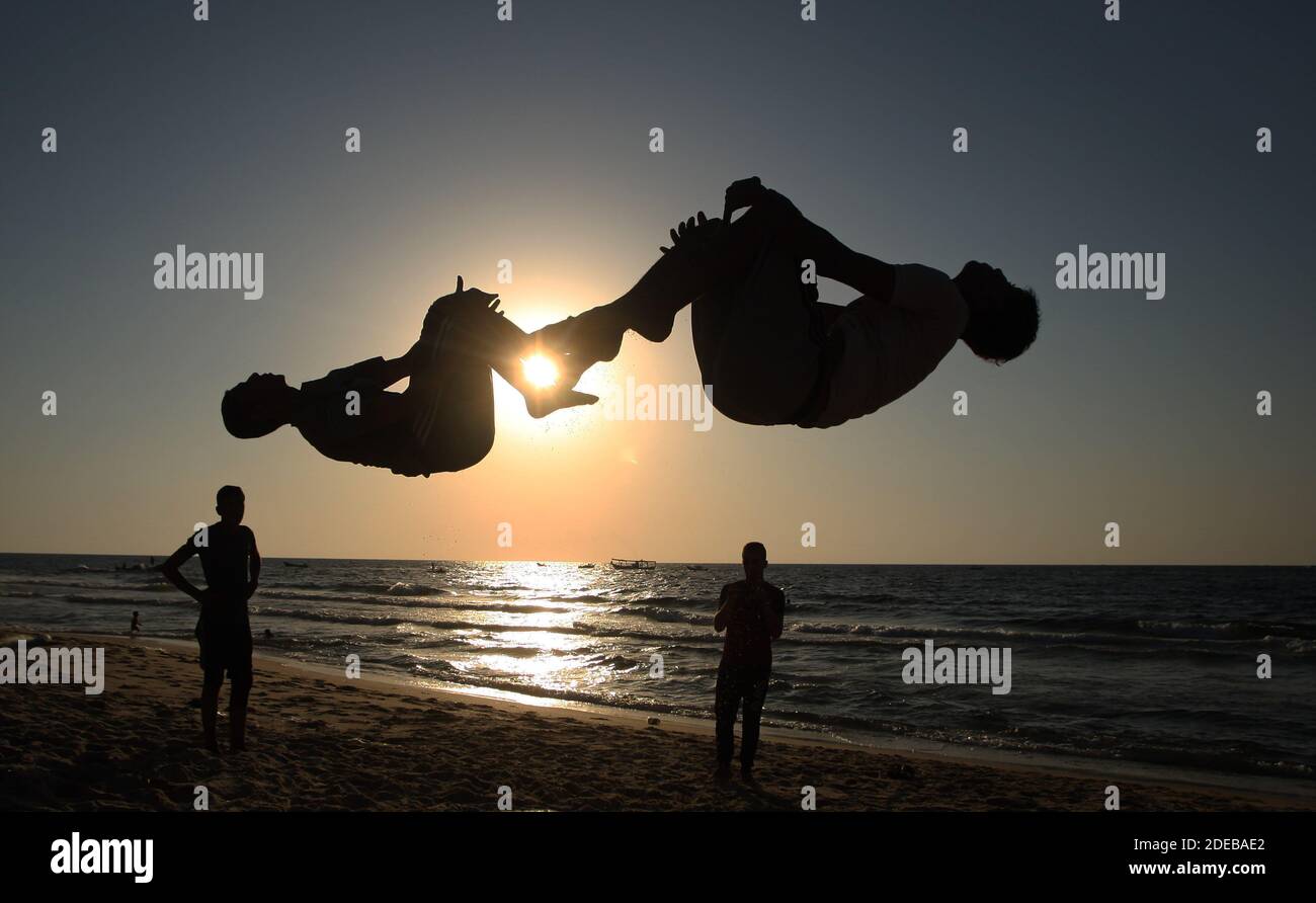 People do flips along a beach by the Mediterranean Sea shore in Rafah in the southern Gaza Strip at sunset on Wednesday on September 2, 2020. The Israeli government has opened the fishing zone off Gaza's coast after an agreement to renew the ceasefire with Hamas. Photo by Ismael Mohamad/UPI Stock Photo