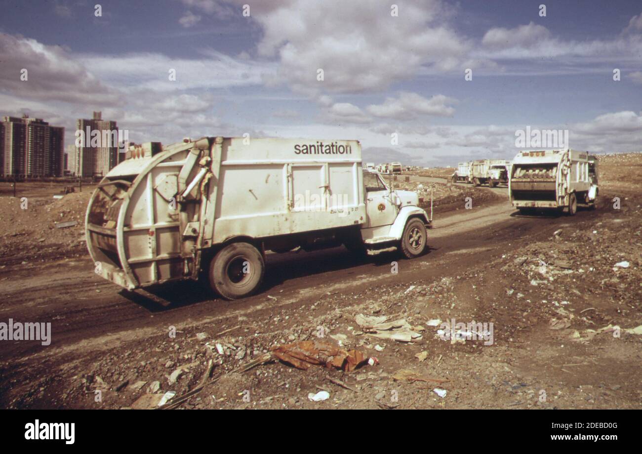 '1970s Photo - (1973) -  Trucks haul waste material to landfill area adjacent to ''co-op city'' a large apartment development in the Bronx' Stock Photo