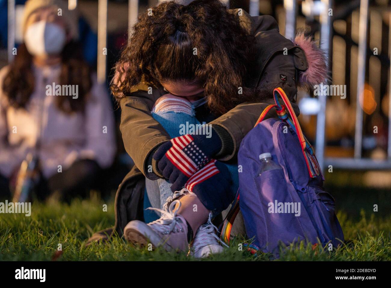Washington, United States. 29th Nov, 2020. A watch party goer bows her head while watching CNN election results at McPherson Square near the White House on election night in Washington, DC, on Tuesday, November 3, 2020. Photo by Ken Cedeno/UPI Credit: UPI/Alamy Live News Stock Photo