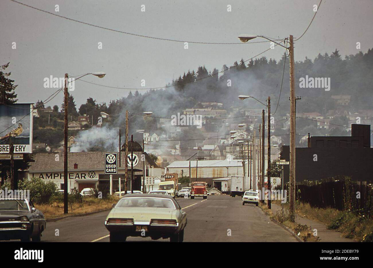 1970s Photos (1972) Cars driving down the street in Astoria Oregon (buick in foreground Stock