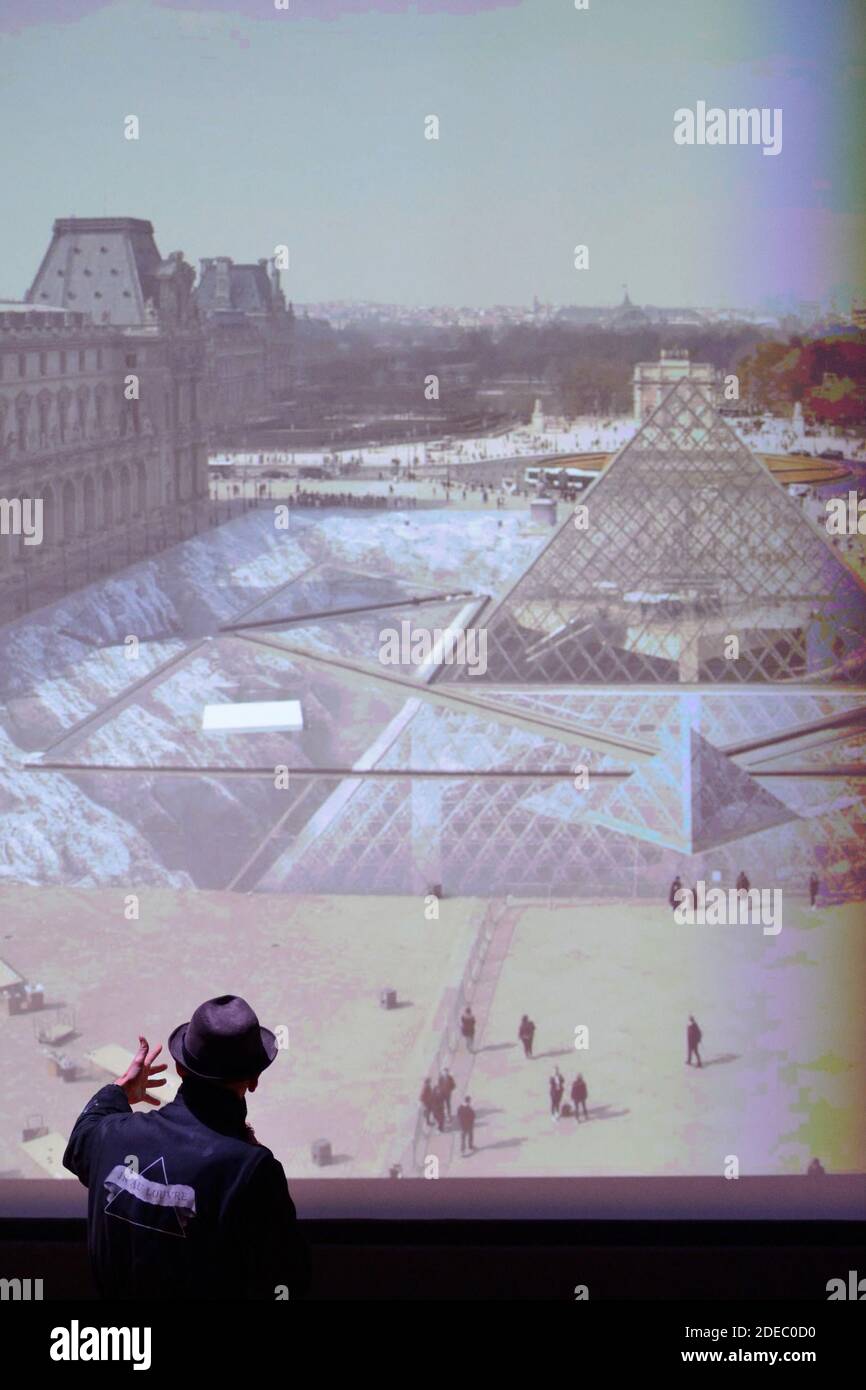 JR attending the 'JR au Louvre & Le Secret de la Grande Pyramide' : Photographer and artist Jean Rene, aka JR, creates a monumental Piece of Art on the scale of Napoleon Court of the Louvre Museum on March 29, 2019 in Paris, France. As part of the celebrations of the 30th anniversary of the Louvre Pyramid, the street artist JR proposes a giant collage to bring out the Pyramid of the Louvre by revealing the foundations of the Napoleon courtyard where it is erected. Photo by Aurore Marechal/ABACAPRESS.COM Stock Photo