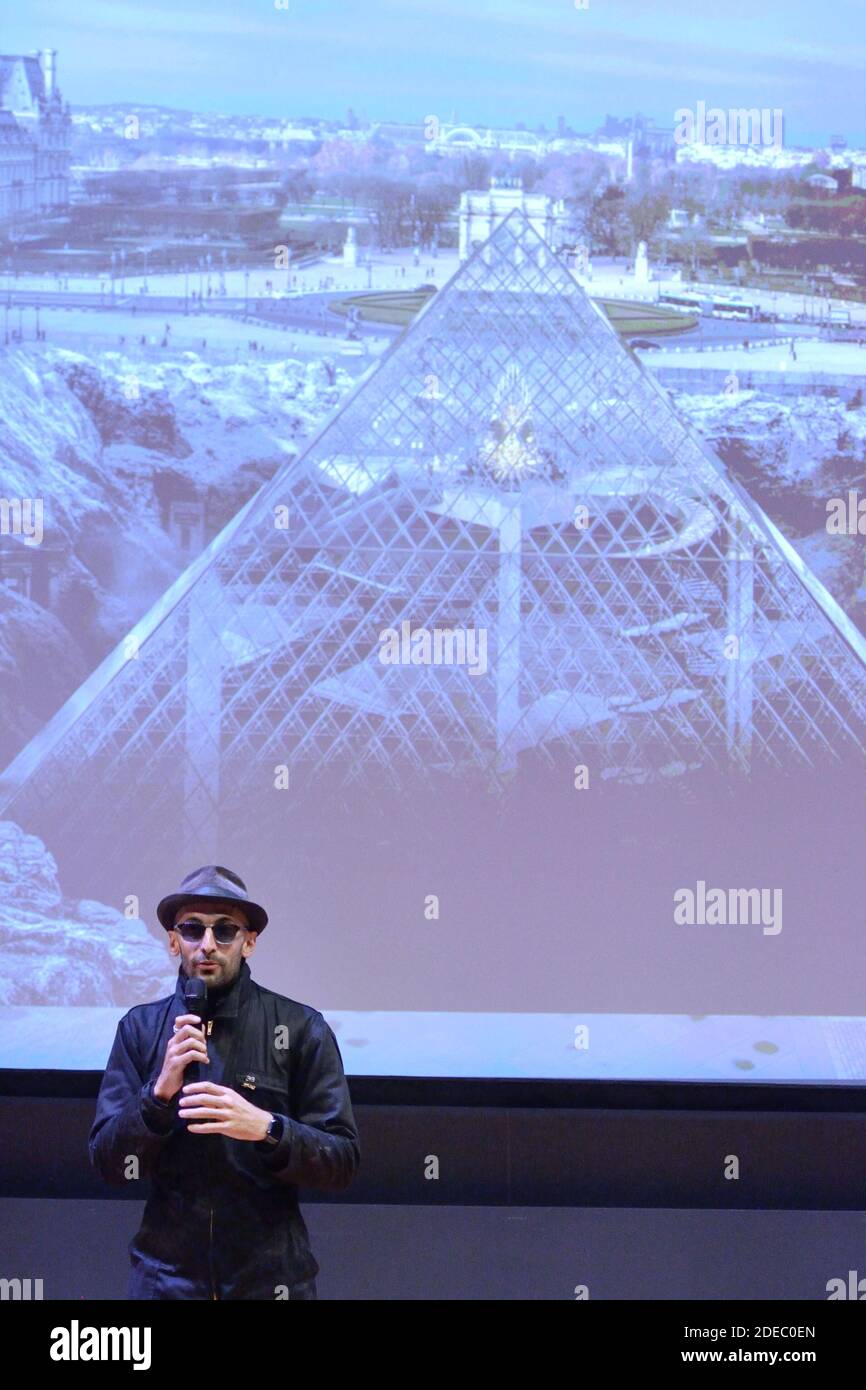 JR attending the 'JR au Louvre & Le Secret de la Grande Pyramide' : Photographer and artist Jean Rene, aka JR, creates a monumental Piece of Art on the scale of Napoleon Court of the Louvre Museum on March 29, 2019 in Paris, France. As part of the celebrations of the 30th anniversary of the Louvre Pyramid, the street artist JR proposes a giant collage to bring out the Pyramid of the Louvre by revealing the foundations of the Napoleon courtyard where it is erected. Photo by Aurore Marechal/ABACAPRESS.COM Stock Photo