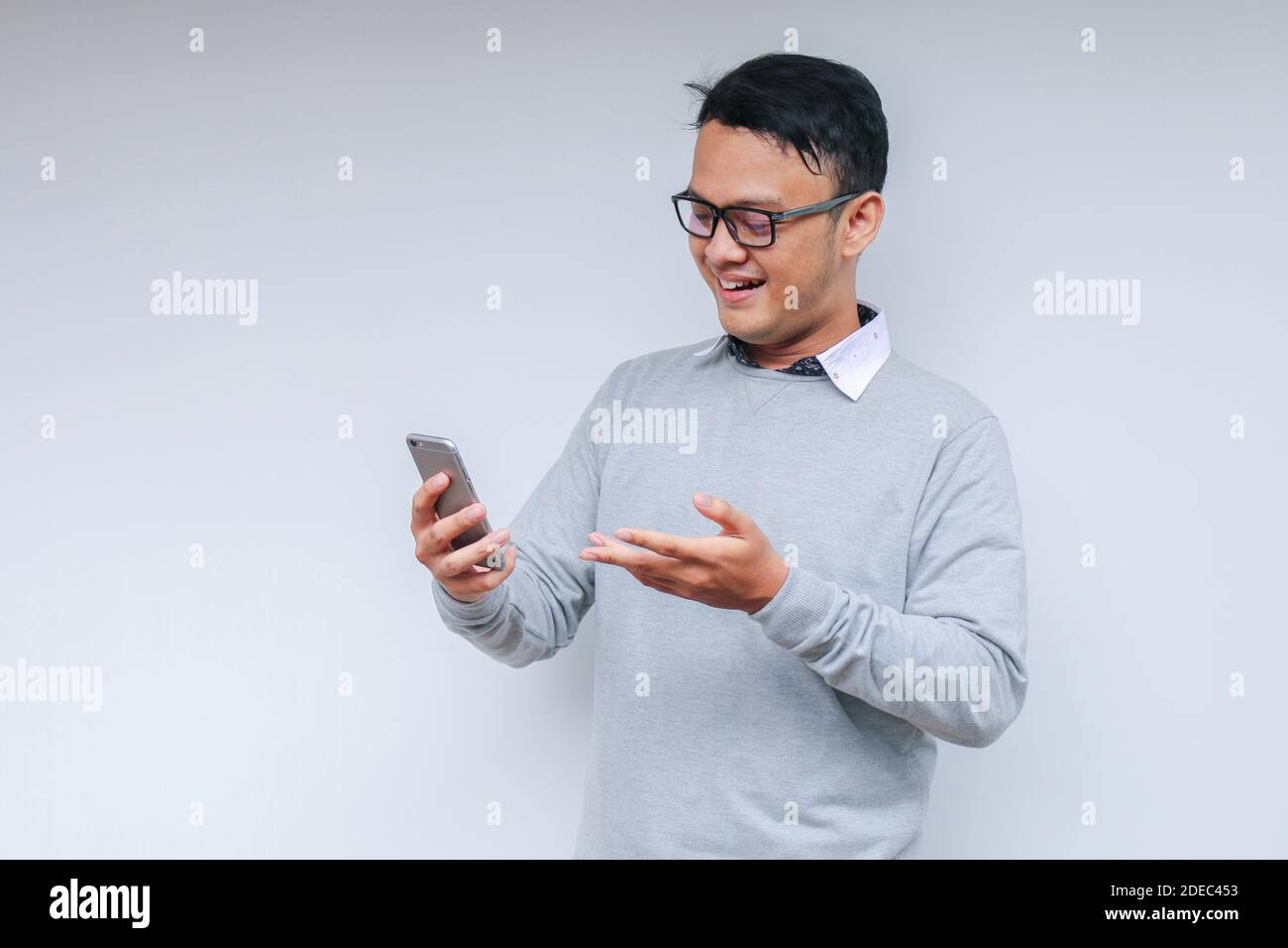 Smart Young asian man is happy and smiling when using smartphone in ...