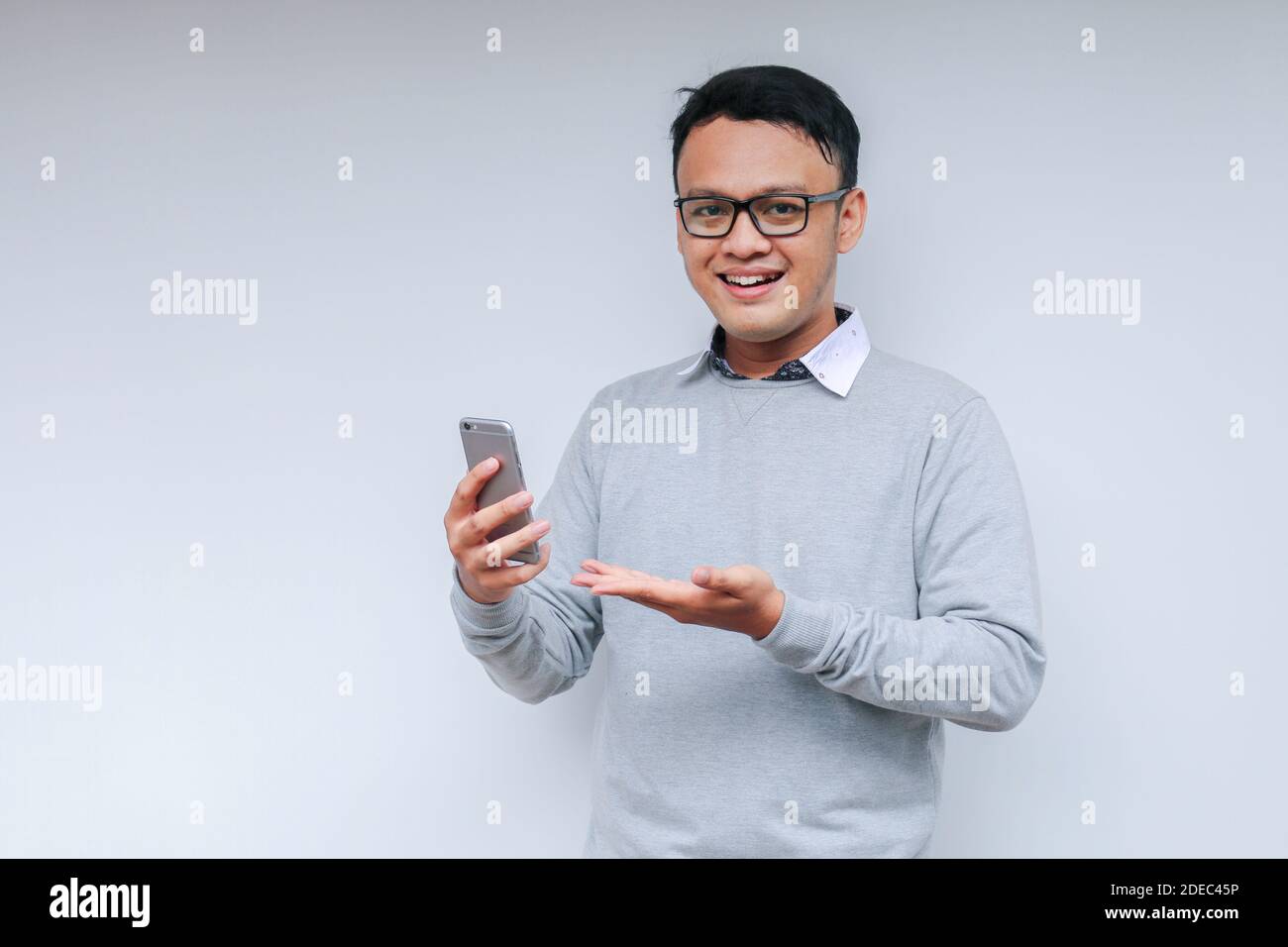 Smart Young asian man is happy and smiling when using smartphone in ...