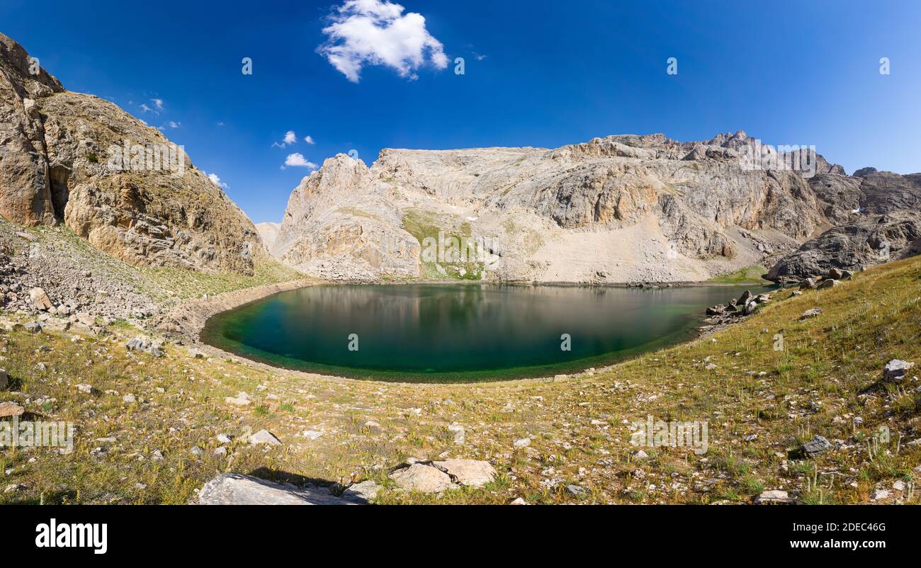 Panoramic view of mountain lake between Bolkar Mountain and Taurus Mountain. Karagol, Nigde, Turkey. It is known ''black lake.'' Volcanic crater. Trav Stock Photo