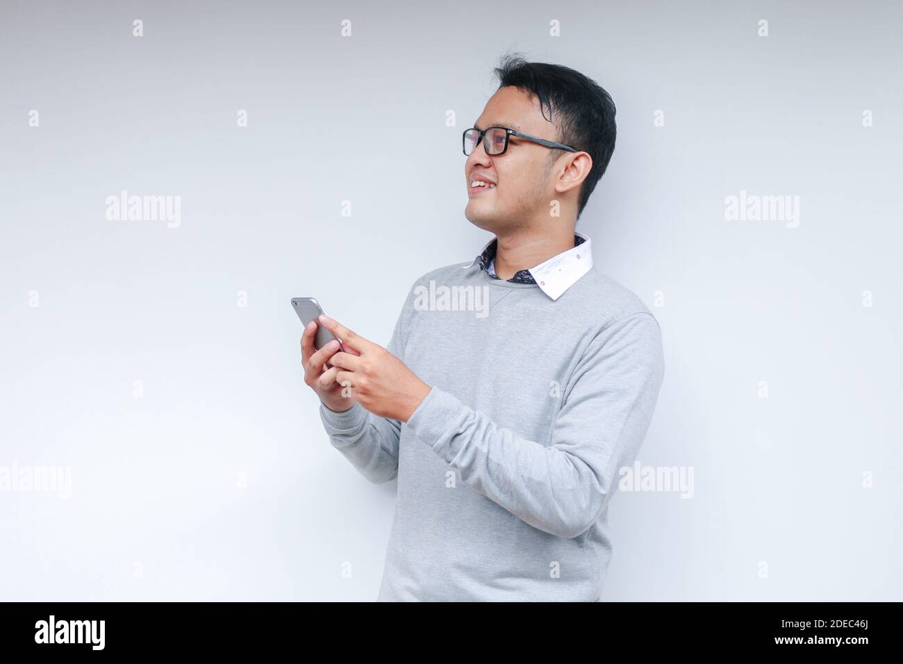 Smart Young asian man is happy and smiling when using smartphone in ...