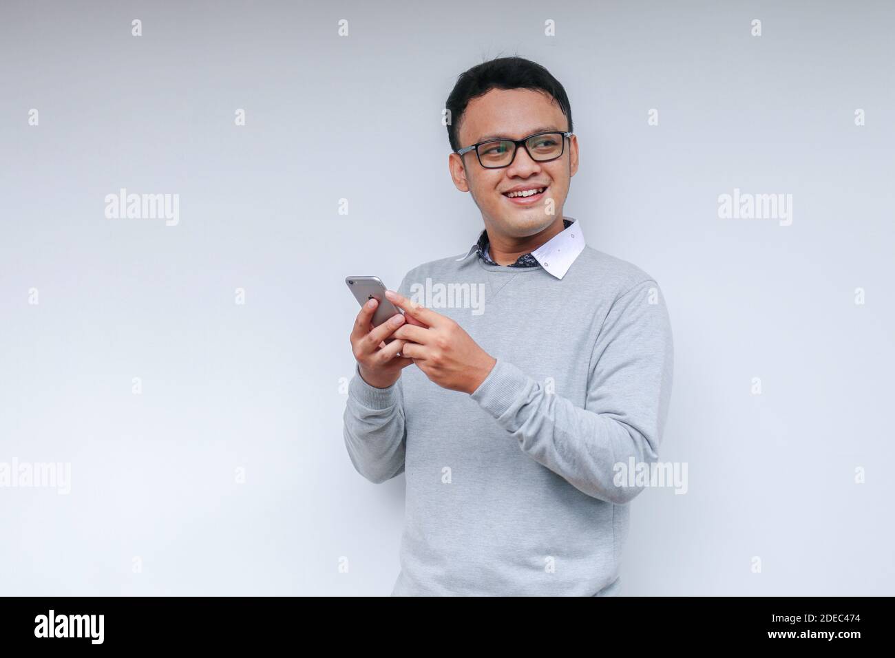 Smart Young asian man is happy and smiling when using smartphone in ...