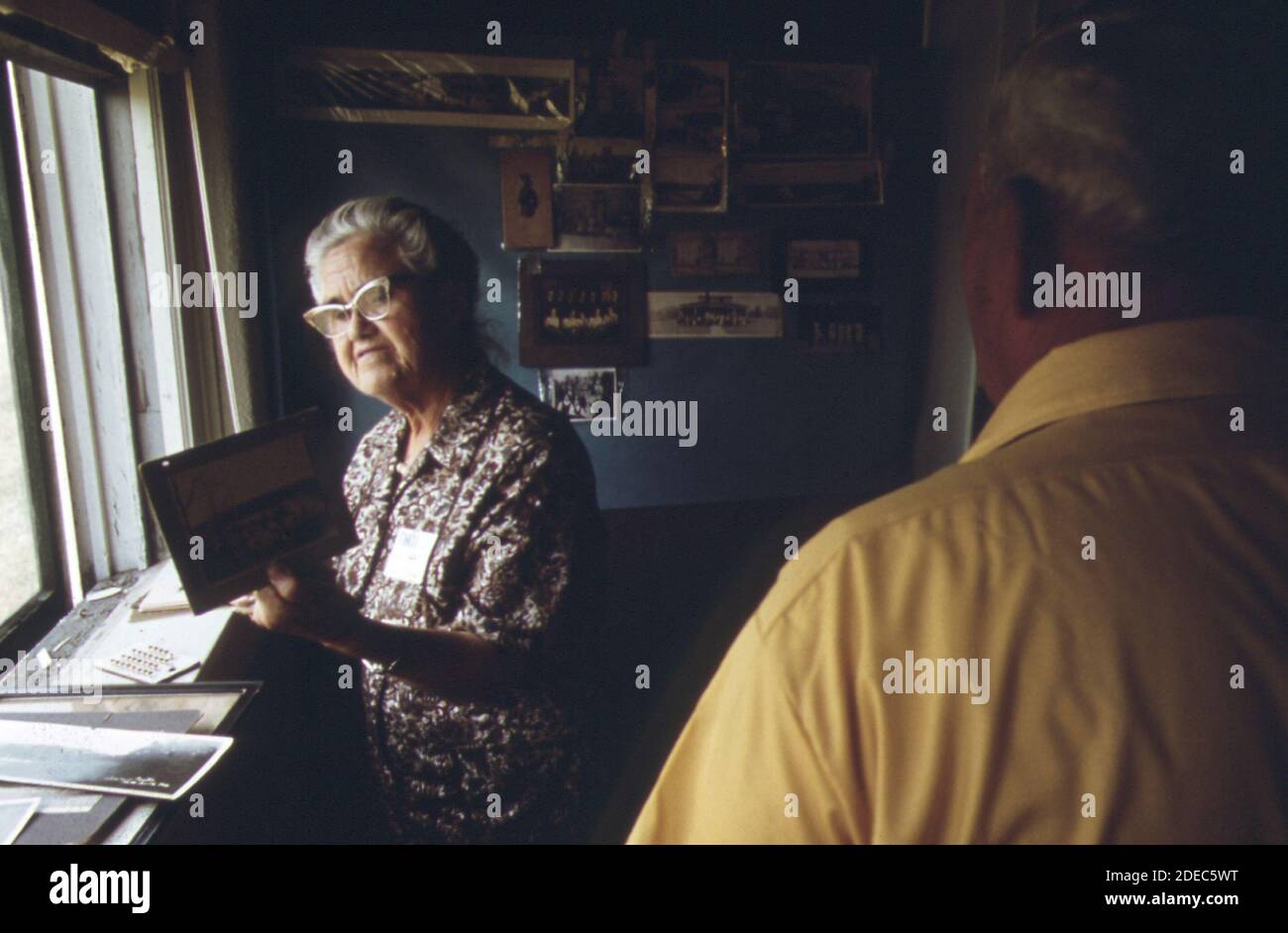 1970s Photos (1973) -  At the second reunion of inhabitants of old Linn Creek; mrs lena hall; retired school teacher; looks at photographs of her former home town. Linn Creek came to an end with the building of Bagnell Dam; which created the Lake of the Ozarks. residents formed new communities in Camdenton and in new Linn Creek  (Lake of the Ozarks Missouri area) Stock Photo