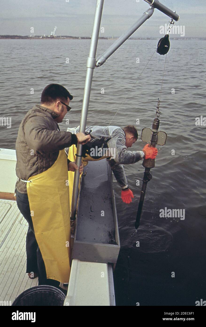 Ron jones of EPA's Annapolis field office takes bottom samples of Baltimore Harbor ca. 1973 Stock Photo