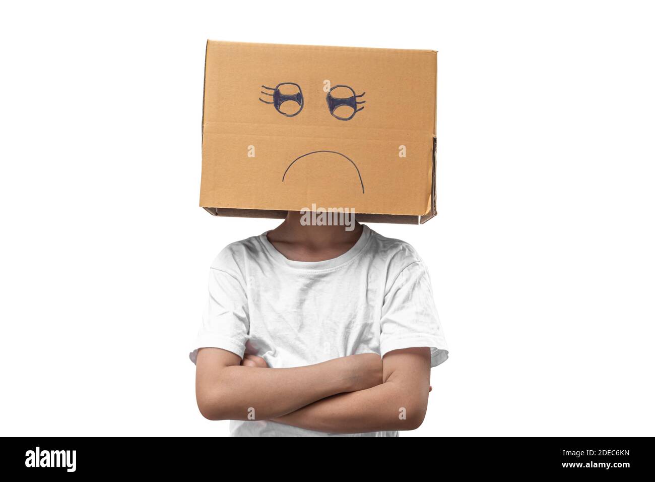 Little girl wearing cardboard box on his head with unglücklich, Isolated on white background. Stock Photo