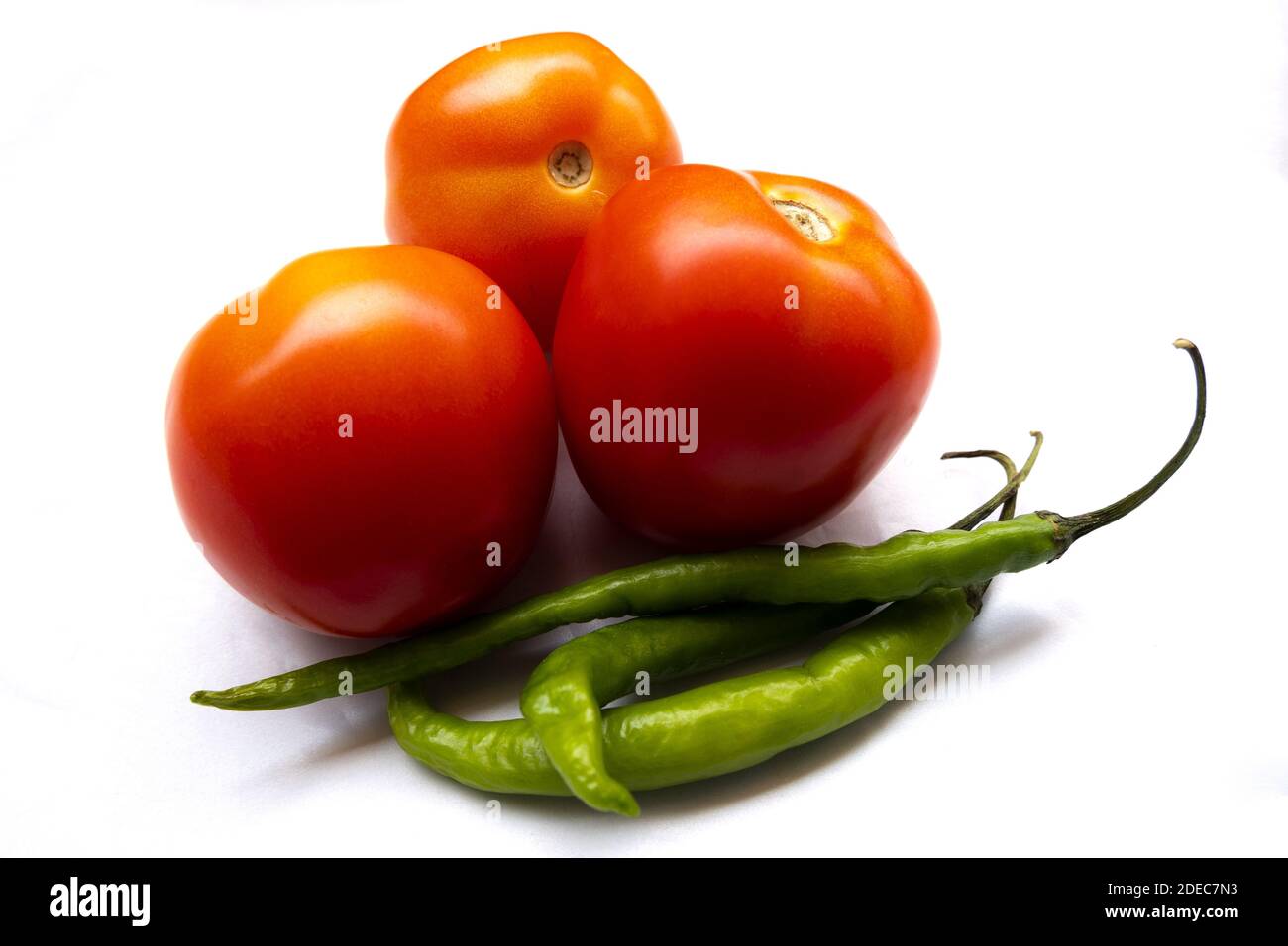 An isolated closeup of tomatoes and green chili peppers on Stock Photo ...