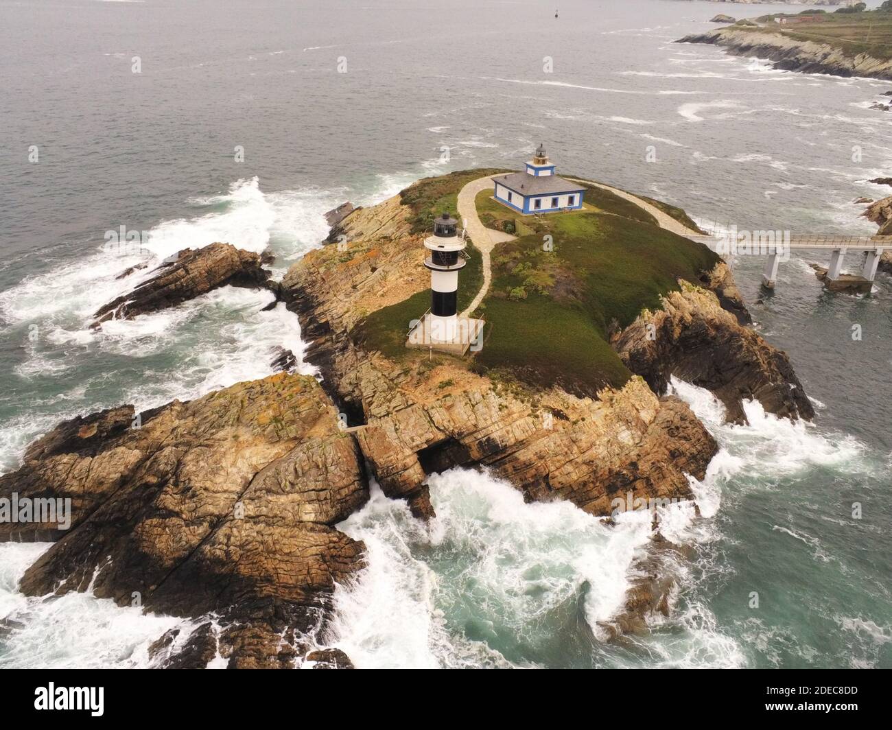 An aerial view of a lighthouse on a rocky formation in Pancha Island in ...