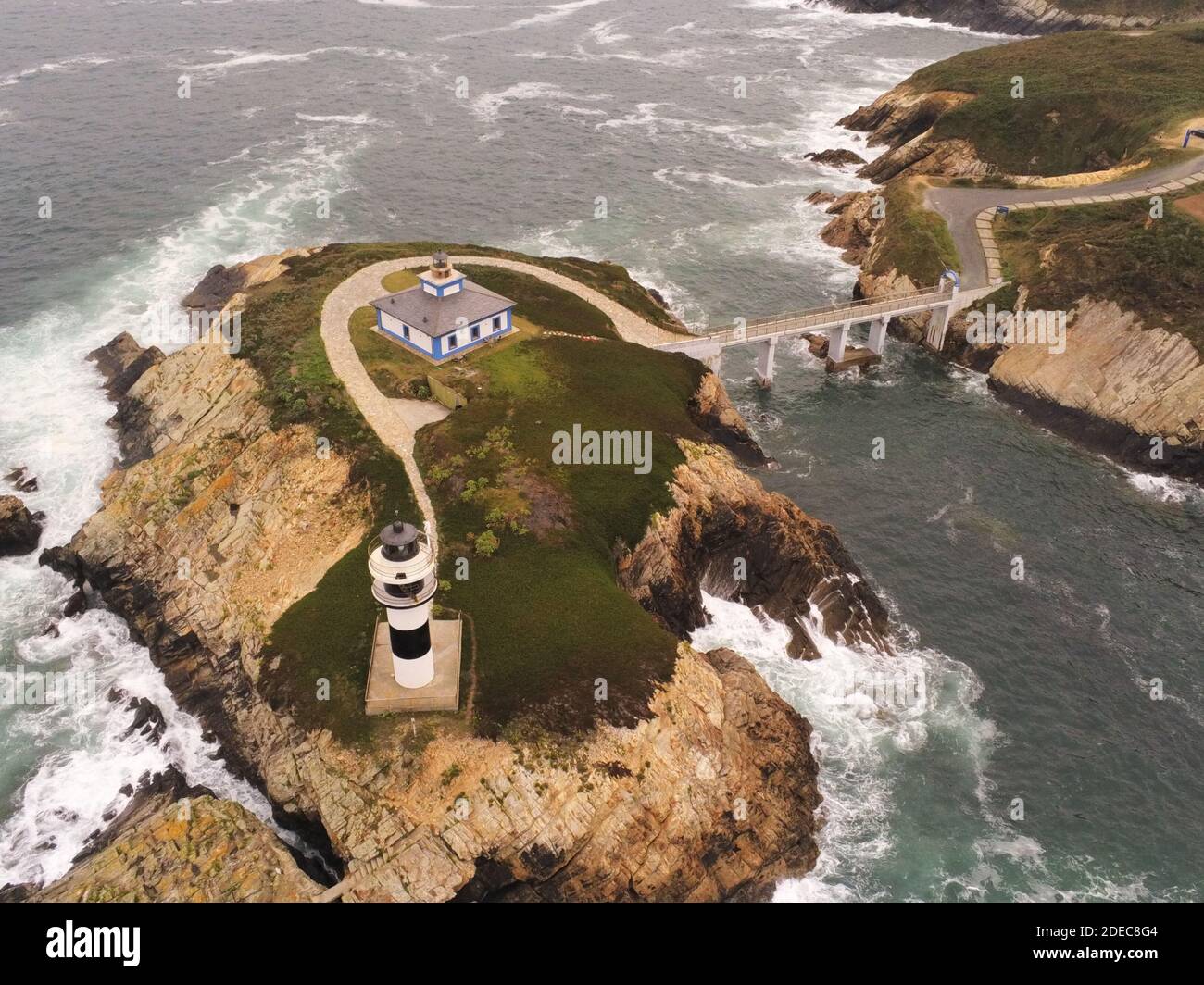 An aerial view of a lighthouse on a rocky formation in Pancha Island in ...