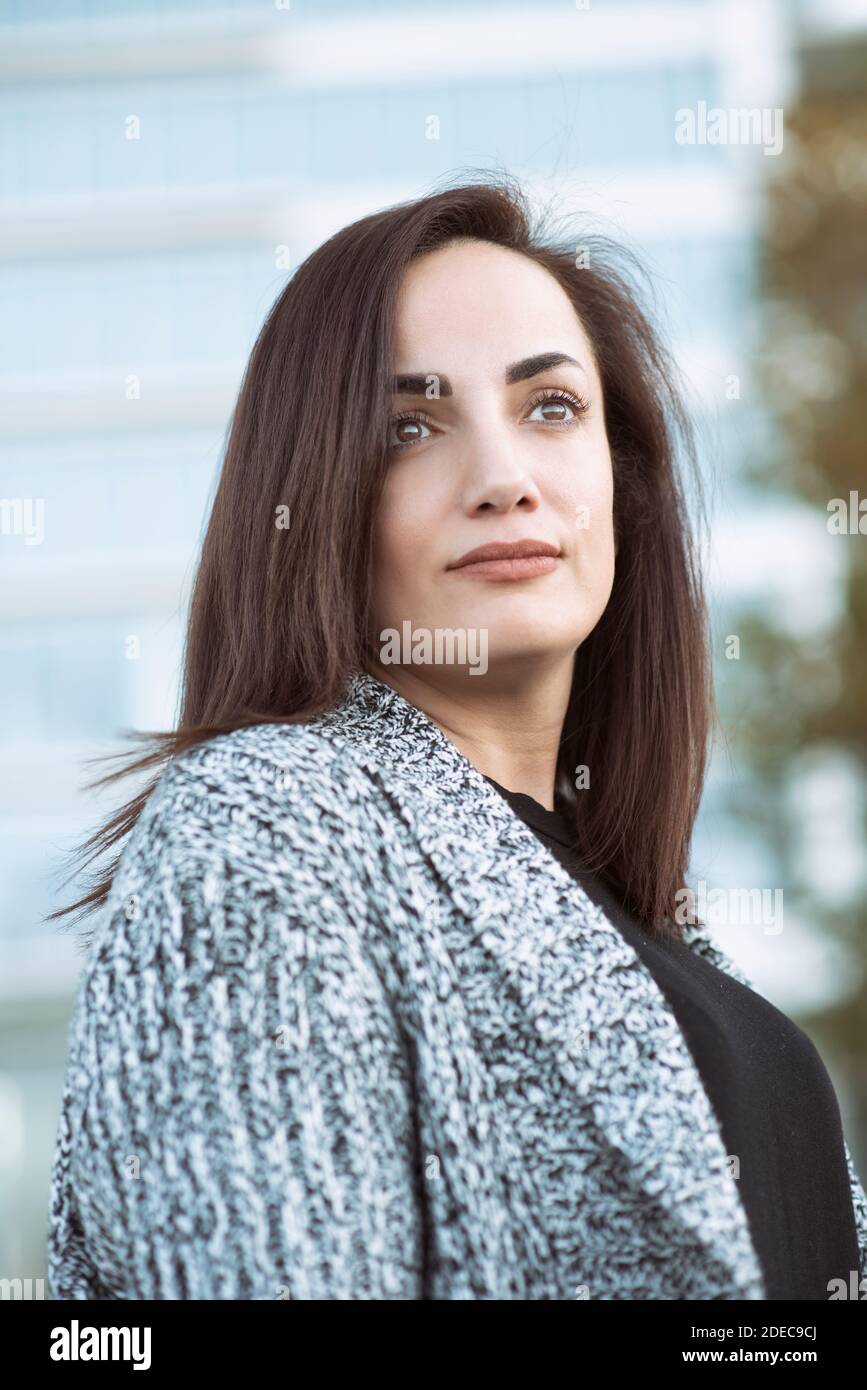 Beautiful pensive woman looking away outdoors Stock Photo