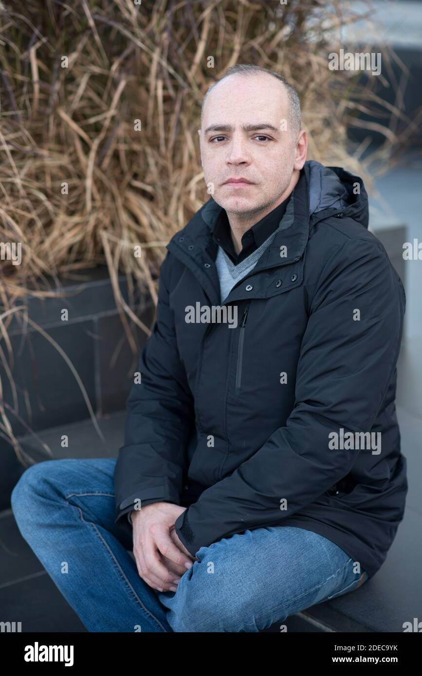 45 years old man sitting outdoors Stock Photo